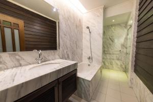 a bathroom with a sink and a shower at Hotel Puri Melaka in Malacca