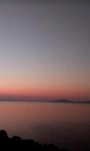 a sunset over a large body of water at Datca Villa Carla Hotel in Datca