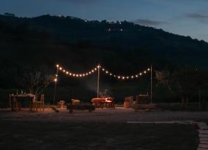 a string of lights over a picnic table at night at B&B Panfilo Farmhouse in Cellino Attanasio