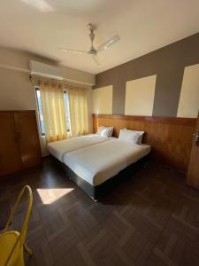 a bedroom with a large white bed in it at Hotel Vajra Inn & Apartments in Pokhara