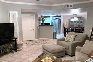 a living room with a couch and chairs and a tv at Gated Mountain View Resort Community, Centrally Located, Three Heated Pool-Spa Complexes, Half-Mile To Hiking! in Phoenix