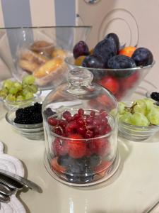a glass jar filled with cherries and other fruit on a counter at Locanda Kon Tiki in Alassio