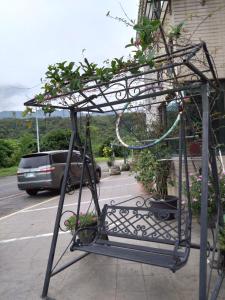 a metal plant stand on the side of a street at No.1 Shelter in Toucheng