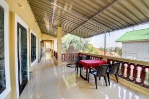 a dining room with a red table and chairs at Hotel Silver Inn in Mahabaleshwar