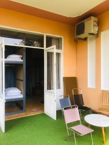a room with green grass and a table and chairs at Quang Ngai Hostel in Quang Ngai
