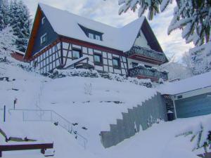 a large house with snow on the side of it at Cosy apartment in Hallenberg near centre in Hallenberg