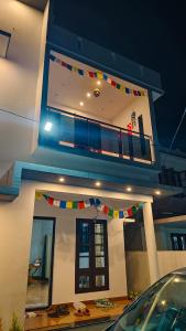 a house with a balcony with flags on it at Enna homestay in Varkala