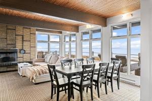 a living room with a table and chairs and a couch at Ptit - 3 bedroom 2 bath Waterfront Oasis in Grand Barachois