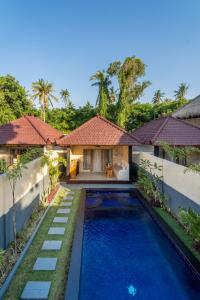 an image of a villa with a swimming pool at Tanis Village - Luxury Villas in Gili Air