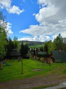 a park with a playground at Domki nad potokiem w Baligrodzie in Baligród