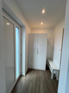 a room with a white cabinet and a window at RK Apartment in Brno