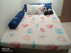a bed with some shoes on top of it at RY Nest in Malaybalay