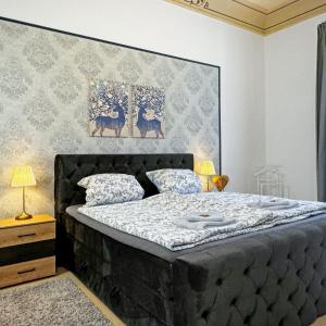 a bedroom with a bed with a large headboard at Ferienwohnung Villa Nieske - Jugendstil Denkmal in Herzberg
