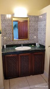 a bathroom with a sink and a mirror at Domaine des Sloughis in Meknès