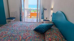 a bedroom with a bed with a blue head board at Appartamenti Tina in Villa Restituta in Ischia