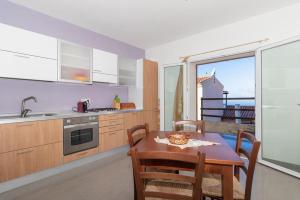 a kitchen with a table and a kitchen with a view at Appartamento bilocale vista mare FT7 in Cascabraga