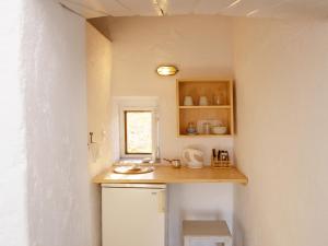 a small kitchen with a counter and a window at Alisideri Studios in Karavostasi