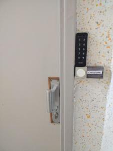 a door with a remote control on a wall at L'Europ'appart : Gare, Center parcs, Parc St Croix in Sarrebourg