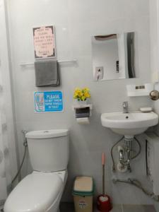 La salle de bains est pourvue de toilettes et d'un lavabo. dans l'établissement Kings' Palms Residence04, à General Santos