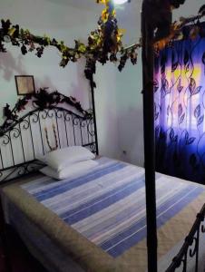 a bedroom with a bed with a black bed frame at VILLA KONSTANTINA in Nea Skioni