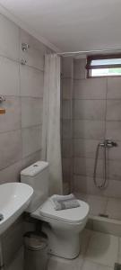 a bathroom with a toilet and a sink and a shower at Avli Apartments in Pyrgadikia