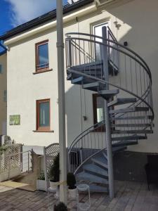 a spiral staircase in front of a house at Protea Inn Ferienwohnungen in Bad Nauheim