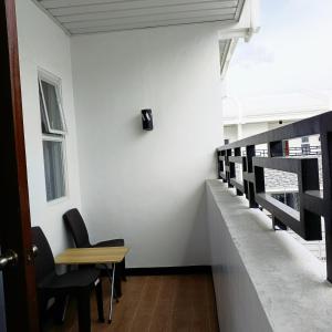 - un couloir avec des chaises et une table dans une chambre dans l'établissement Kings' Palms Residence04, à General Santos