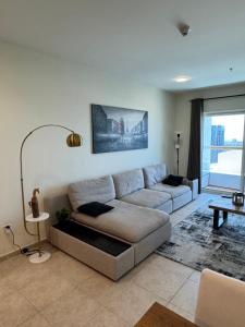 a living room with a couch and a table at Stunning 1 BR Apartment in Dubai Marina in Dubai