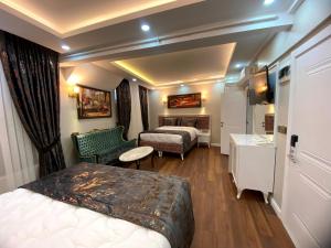 a hotel room with two beds and a bathroom at Solomon's Mansion Hotel Istanbul in Istanbul