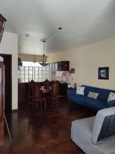 a living room with a blue couch and a table at casa na Torre in Machico