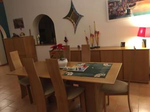 a dining room with a wooden table and chairs at Au Murmure des Cascades in La Roque-sur-Cèze
