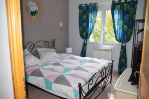 a bedroom with a bed and a window at Au Murmure des Cascades in La Roque-sur-Cèze