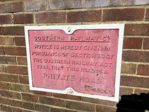 a sign on the side of a brick wall at Old Ningwood Station Bed & Breakfast in Shalfleet
