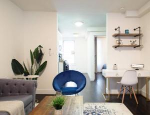 a living room with a blue chair and a table at Lovely 4 BR in NYC! in New York