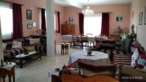 a living room with couches and a dining room at Domaine des Sloughis in Meknès
