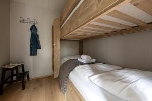 a bedroom with two bunk beds and a table at 37, located in a quiet & wooded area! in Oisterwijk