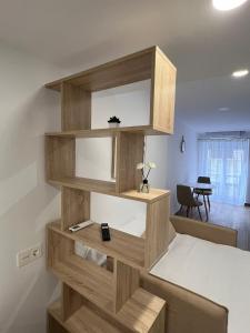 a wooden book shelf in a room with a desk at White House in Castellón de la Plana