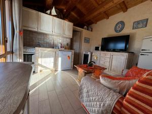 a kitchen with a couch and a table in a room at Casetta Vittoria in Palau