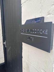 a sign on the side of a building at The Penruddocke Arms in Dinton