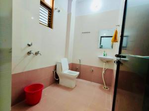 a bathroom with a toilet and a sink at Green View Apartments F1 in Varanasi
