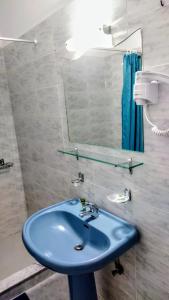 a bathroom with a blue sink and a mirror at Dardiza Stay in Ermioni
