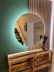 a hallway with a circular mirror and a staircase at Moselhotel Weinhaus Simon in Wintrich