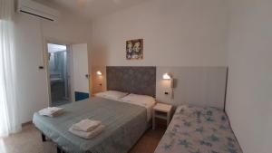 Postel nebo postele na pokoji v ubytování Hotel Luana