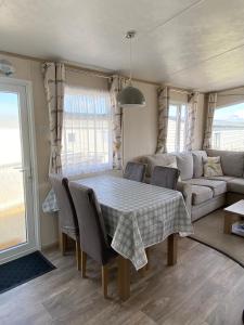 a living room with a table and a couch at Stunning Caravan on Swanage Bay View Holiday Park in Swanage