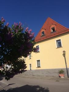 a large yellow building with a red roof at Otterbau in Belgern