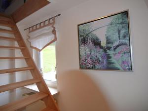 a painting hanging on a wall next to a staircase at Wonderful Apartment in Elpe with Garden in Elpe
