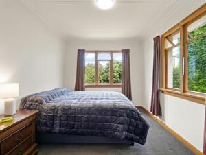 但尼丁的住宿－Napier View，一间卧室设有一张床和一个窗口