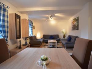 a living room with a table and a couch at Wonderful Apartment in Elpe with Garden in Elpe
