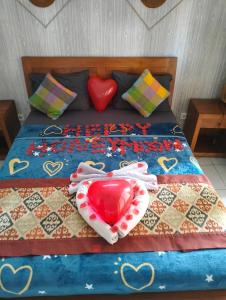 a bed with two hearts on top of it at Nami House in Ubud