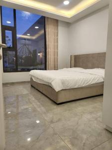 a bedroom with a bed and a large window at La Seema sea view chalet in Madaba